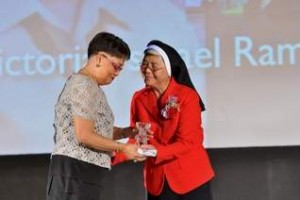 Recognition: Victoria Ysmael Ramos received her crystal latte trophy from Santa Barbara School principal Sister Jeanette Marie Pangelinan for 29 years of service during the schools 60th celebration. (Jonathan Abella/For Northern Weekly)