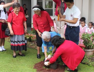 Sr. Bernadette Marie Leon Guerrero, former principal and one of the school's pioneer teachers plant the Guasali tree to commemorate the 65th Anniversary of SBCS.